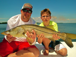 Father and son holding snook caught off Boca Grande.