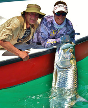 Boca Grande Tarpon charter fishing customer with large tarpon next to Captain Kelly.