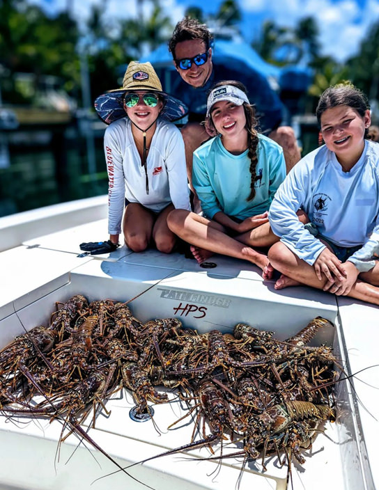 Family with large lobster catch.