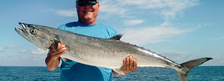Florida Inshore Xtream Fishing Charters customer holding a large king mackerel caught on a charter trip in Florida.