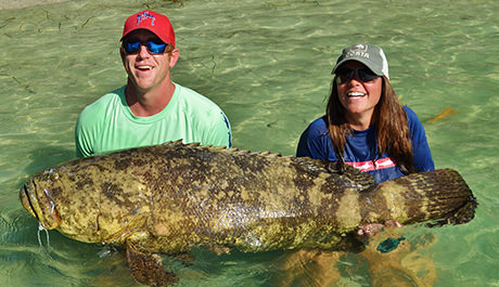 Couple holding very large Goliath Grouper caught wuth Florida Inshore Xtream Fishing Charters around Boca Grande, Englewood and Pine Island Sound.